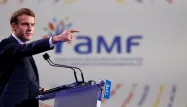 Macron défendant son bilan face aux maires de l'AMF