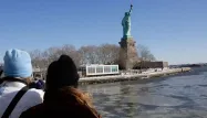 Devant la statut de la Liberté, l'Hudson River est partiellement gelée.