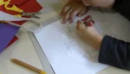 Un élève en classe de maternelle fait un dessin, enfant, école, classe,