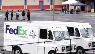 Des employés de Fedex devant les locaux après une fusillade