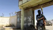 Un milicien armé garde l'entrée d'un camp à Benghazi, en Libye, le 16 mai 2014.