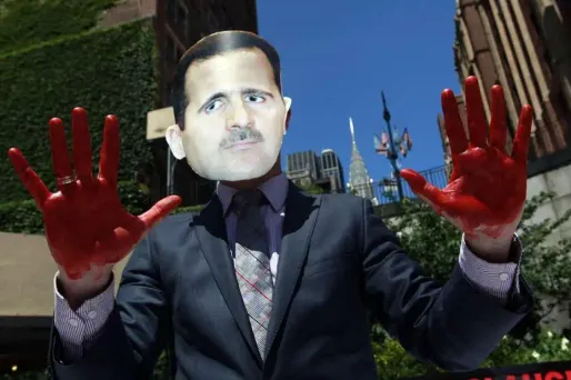 Un manifestant, avec un masque du président syrien, lors d'une manifestation devant le siège des Nations unies.